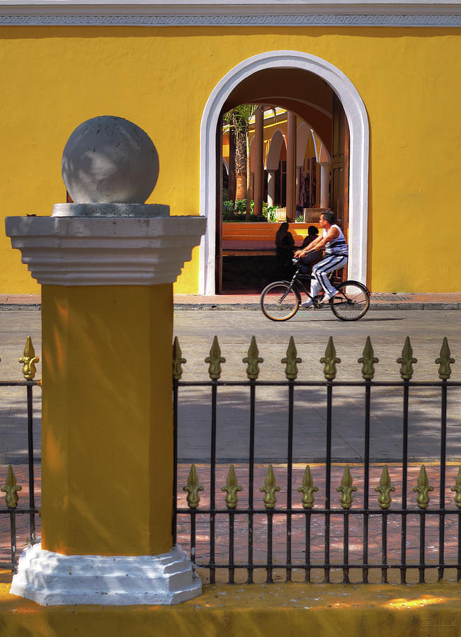 Valladolid Colors - street scene with bicyclist and yellow architecture Photograph by Peter Herman