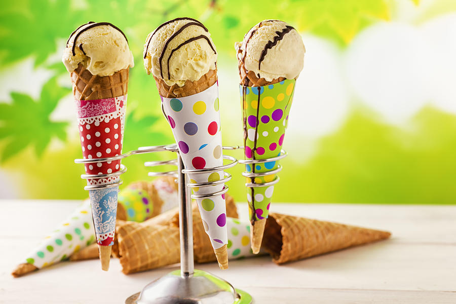 Vanilla ice cream cones with chocolate sauce Photograph by GMVozd