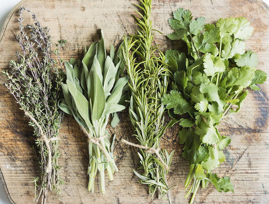 Variety of fresh green herbs on wooden table at home Photograph by Westend61 Variety of fresh green herbs on wooden table at home Photograph by Westend61