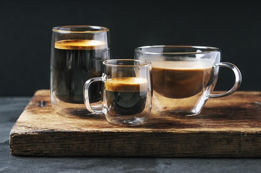 Variety of mugs with coffee and espresso on black background Photograph by Claudia Totir