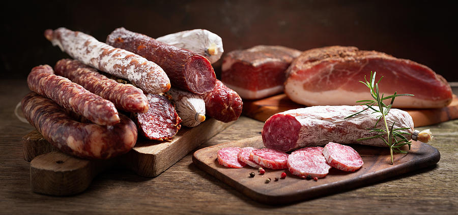 Various kind types of salami, speck and sausages Photograph by Nitrub