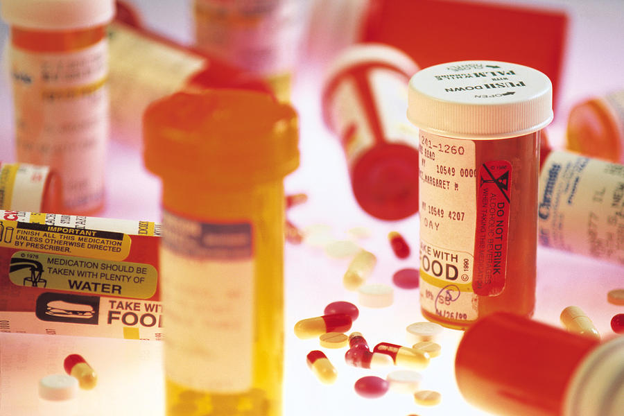 Various prescription bottles and pills Photograph by Comstock