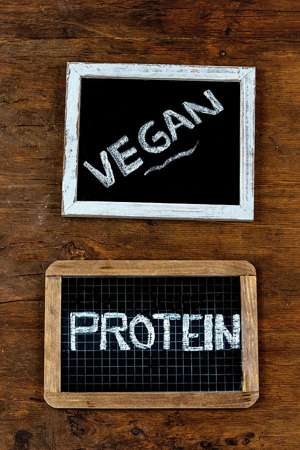 Vegan and Protein written in chalk on a chalkboard on a rustic