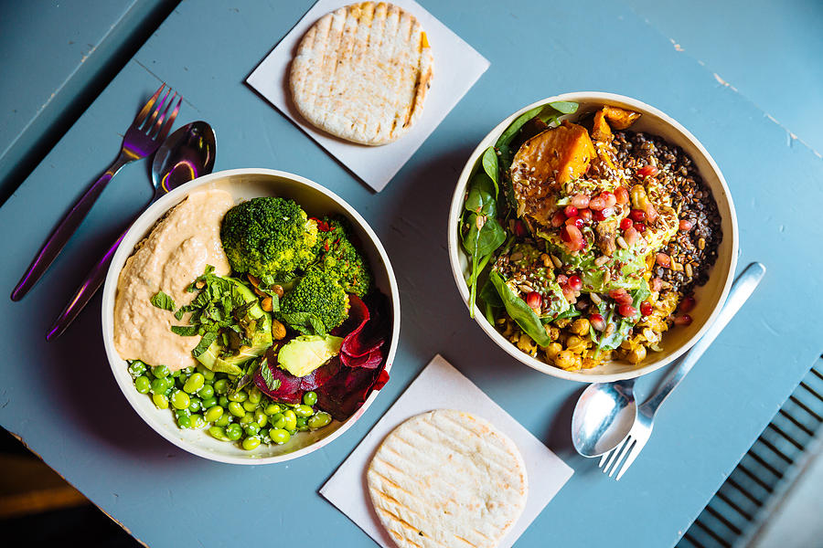 Vegan bowls with various vegetables and seeds, high angle view Photograph by Alexander Spatari