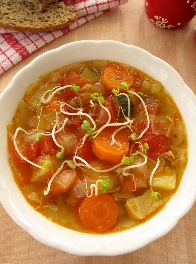 Vegetable soup with sprouts in white bowl Photograph by Tanai