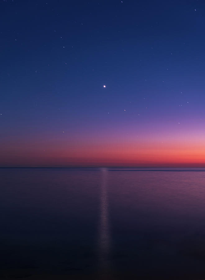 Venuss reflection over the sea at dusk Photograph by Mirko Chessari