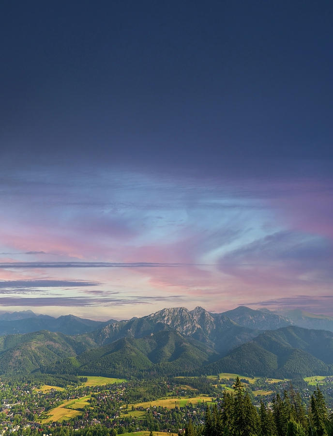 Vertical view of mountains in nature of sleeping knight tatra mountain covered with dramatic clouds aka as giewont and dramatic sunset or sunrise located in Zakopane, South Poland, Europe. Photograph by Arpan Bhatia