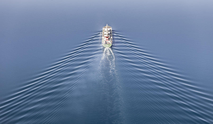 Vessel at sea with perfect symmetrical waves Photograph by Mats Anda