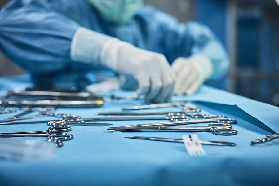 Veterinarian preparing surgical instruments Photograph by Morsa Images