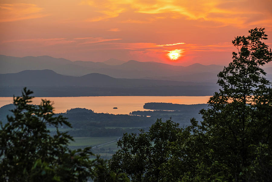 Vibrant sunset through trees Lake Champlain and the Adirondacks from Mount Philo Charlotte Vermont Photograph by Toby McGuire