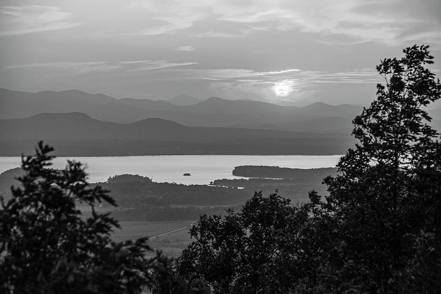 Vibrant sunset through trees Lake Champlain and the Adirondacks from Mount Philo Charlotte VT BW Photograph by Toby McGuire