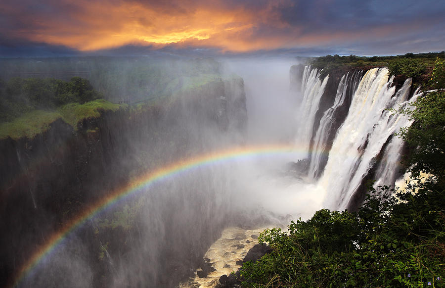 Victoria Falls sunset with rainbow, Zambia Photograph by Dietmar Temps
