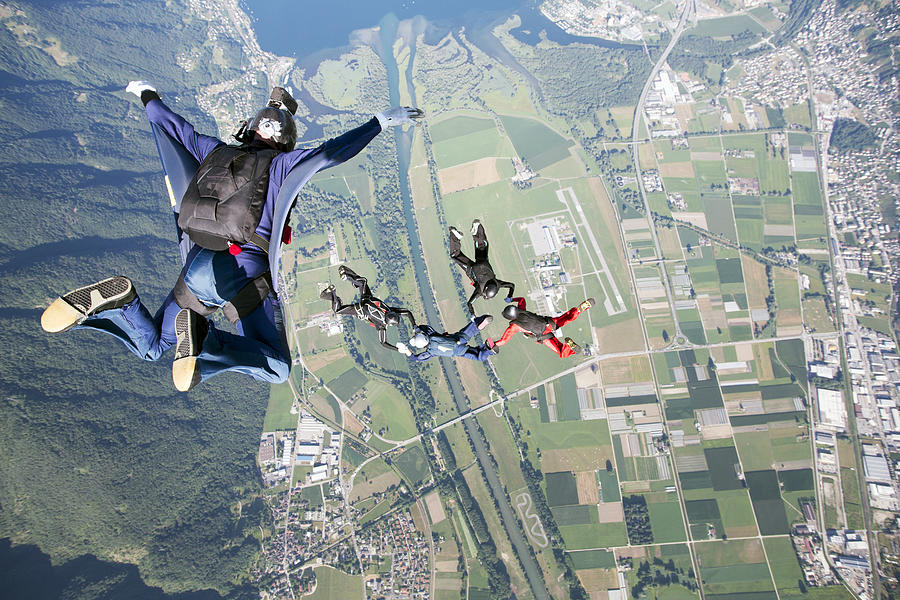 Video man filming the skydivers from above Photograph by Oliver Furrer