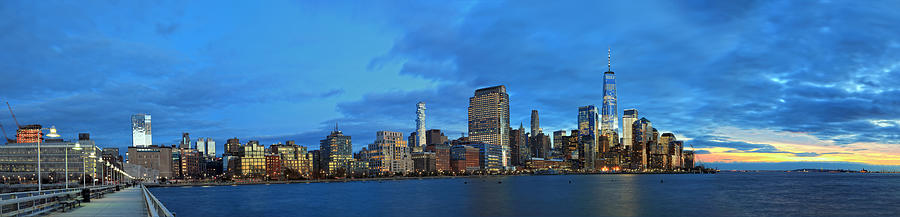 View from Pier 34 in Hudson River at the Skyline of Downtown Manhattan with One World Trade Center at dusk Photograph by Rainer Grosskopf
