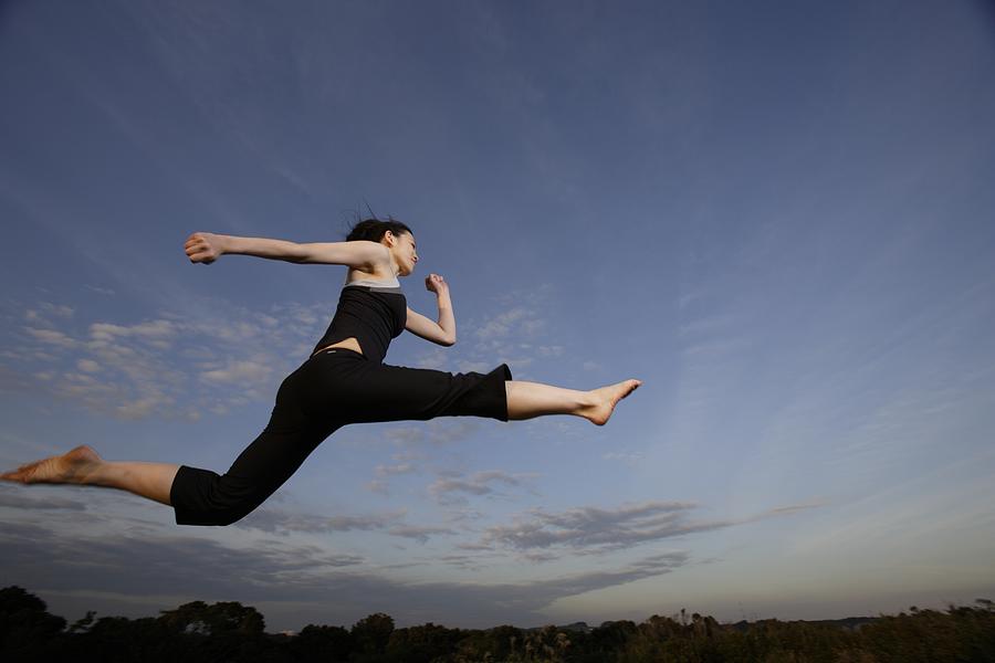 View of a young woman jumping in the air Photograph by imagewerks RF View of a young woman jumping in the air Photograph by imagewerks RF
