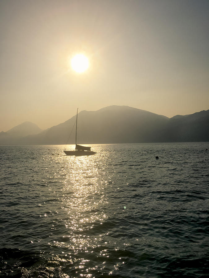 View of Lake Garda with Sailboats at sunset, Brenzone Sul Garda Photograph by Larissa Veronesi