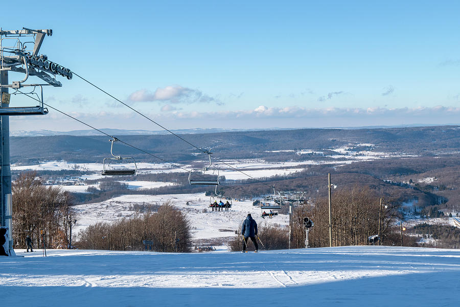 View of skiers from top of mountain on winter day Photograph by Dan Friend