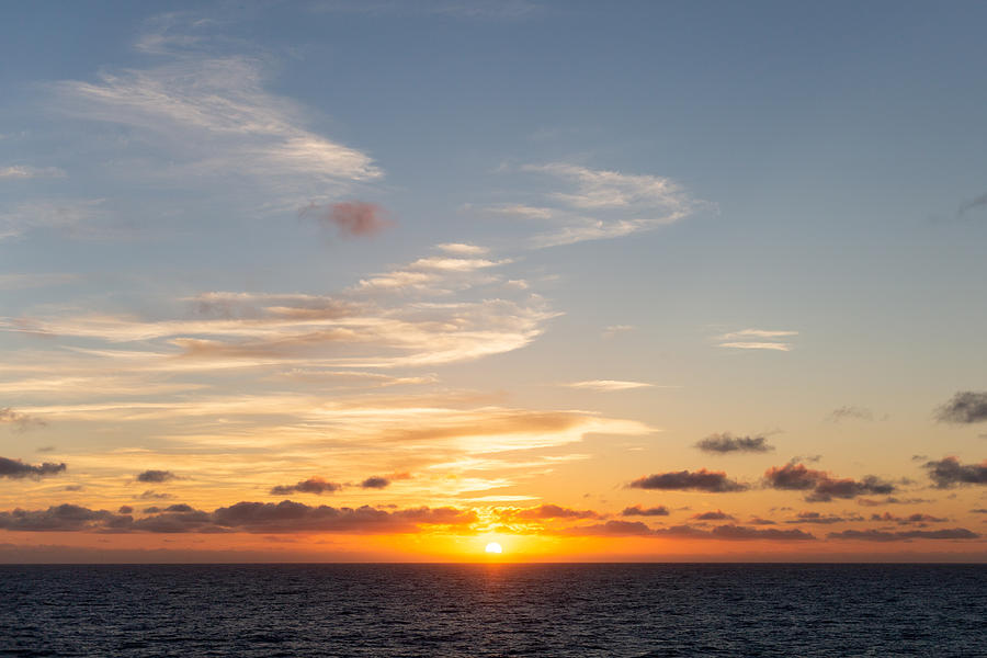 View of the sun setting over the Atlantic Ocean from RMS Queen Mary 2 Photograph by Photographed by Victoria Phipps ©