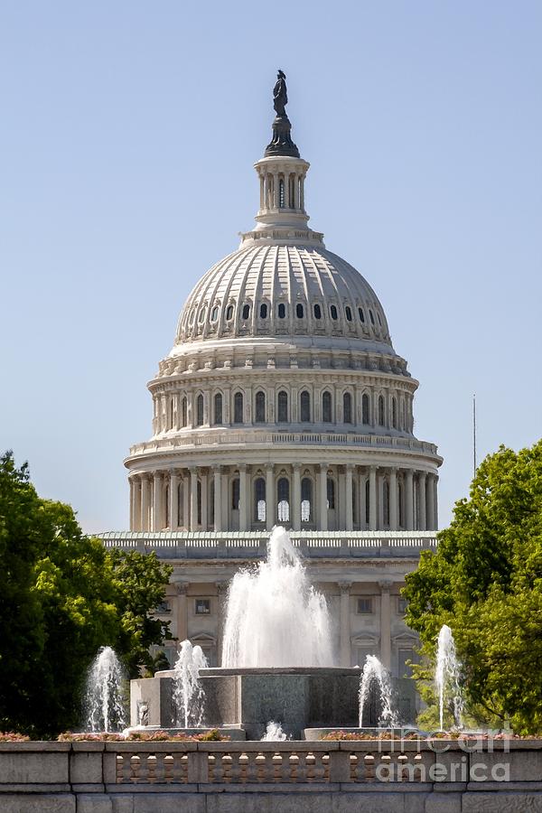 View of the US Capitol Building and dome over a fountain on the north side in Washington DC Photograph by William Kuta