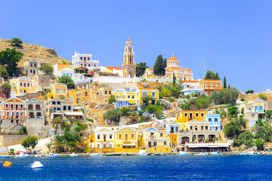 View over harbour to colourful houses and church, Symi, Dodecanese Islands, South Aegean, Greece Photograph by Andrei Troitskiy