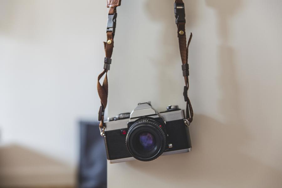 Vintage Painting - Vintage analog 35mm film camera hanging on a wall by Les Classics