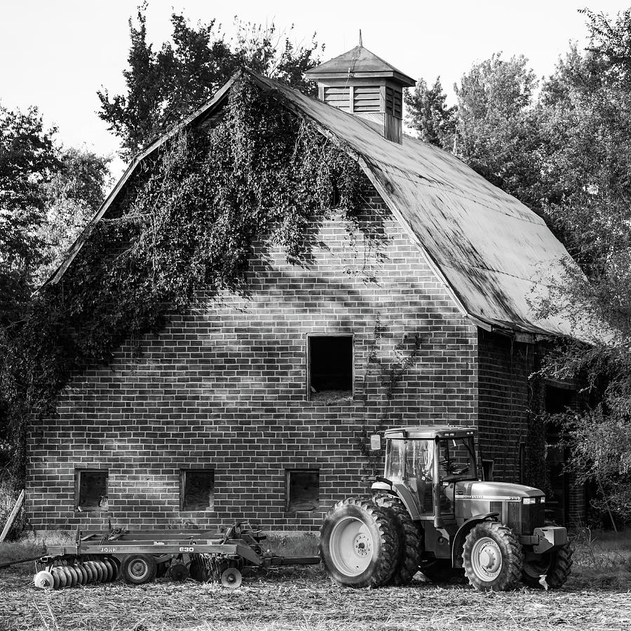 Black And White Photograph - Vintage Barn and Farm Tractor - Black and White 1x1 by Gregory Ballos