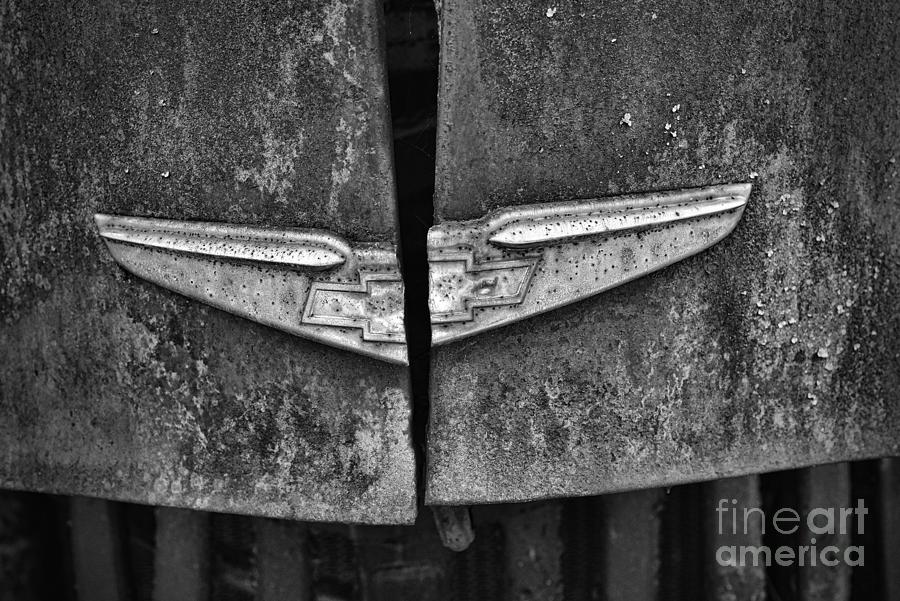 Vintage Chevy Hood Emblem black and white Photograph by Paul Ward