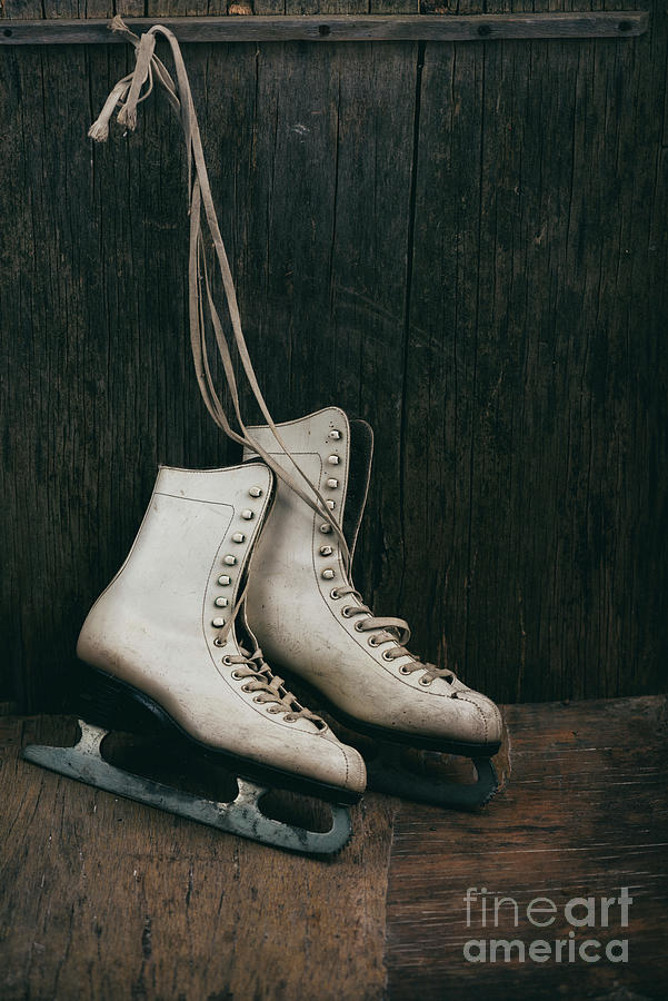 Vintage ice skates on dark wooden background Photograph by Jelena Jovanovic