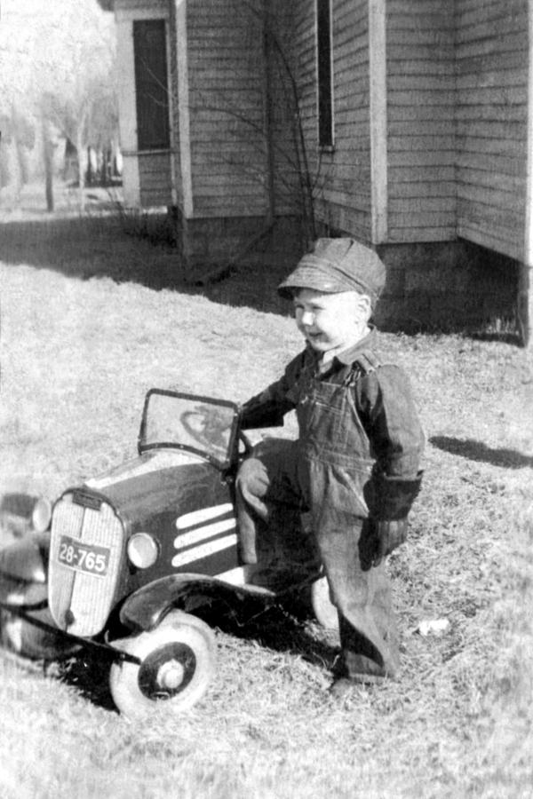 Vintage image of boy with toy tractor Photograph by Jupiterimages