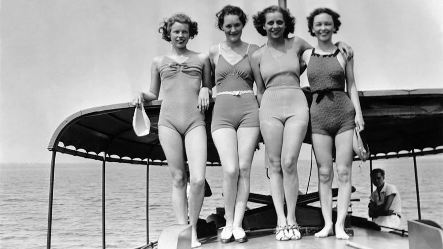 Vintage image of women in bathing suits standing on boat deck Photograph by Jupiterimages