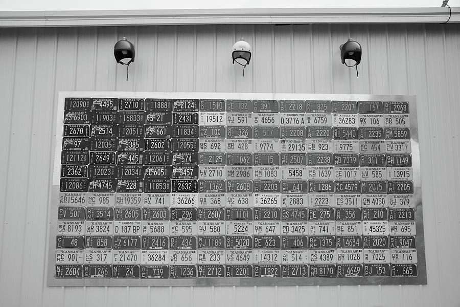 Vintage Kansas license plates as an American Flag on Historic Route 66 in Galena Kansas in BW Photograph by Eldon McGraw