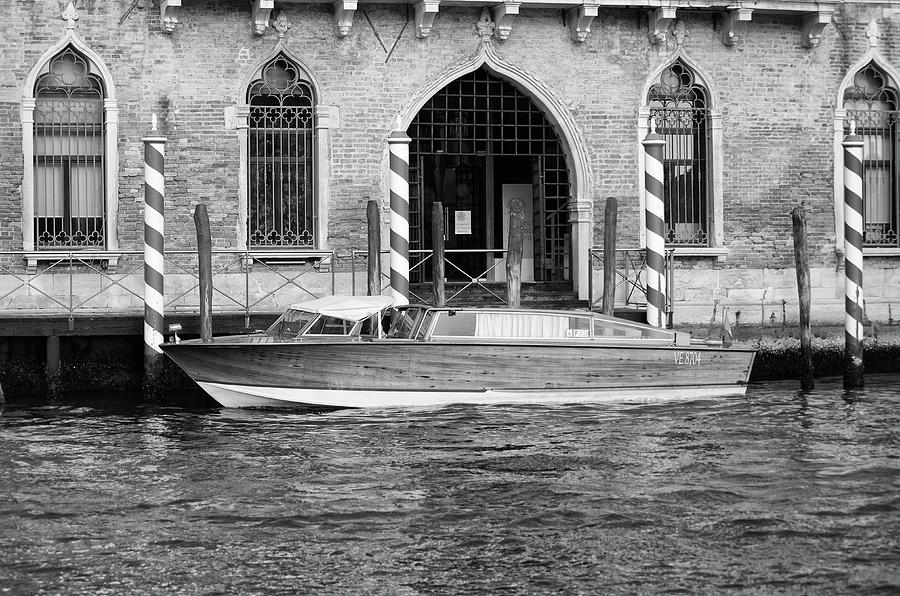 Vintage Runabout Boat and Striped Venetian Mooring Poles Grand Canal Venice Italy Black and White Photograph by Shawn OBrien