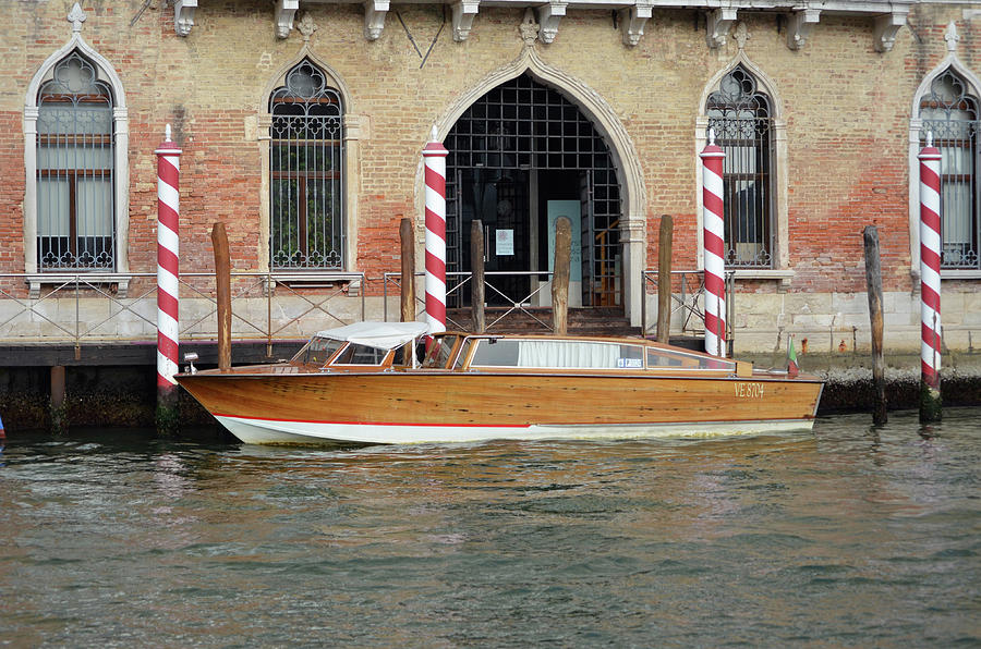Vintage Runabout Boat and Striped Venetian Mooring Poles Grand Canal Venice Italy Photograph by Shawn OBrien