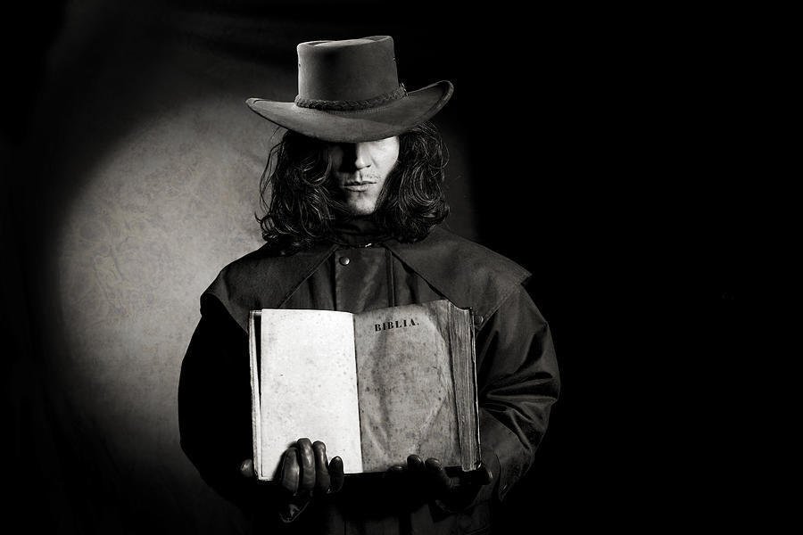 Vintage Style Wild West Gunslinger Holding Ancient Bible Book Photograph by Philartphace