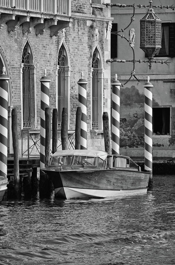 Vintage Wood Runabout Boat Docked at Striped Venetian Mooring Poles Venice Italy Black and White Photograph by Shawn OBrien