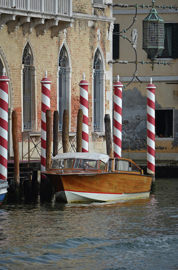 Vintage Wood Runabout Boat Docked at Striped Venetian Mooring Poles Venice Italy Photograph by Shawn OBrien