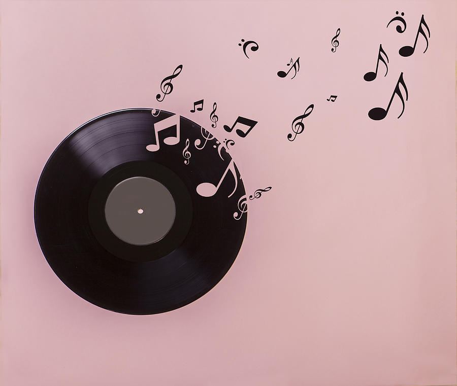 Vinyl record on pink background. Several musical notes are born of the vinyl record Photograph by Juana Mari Moya
