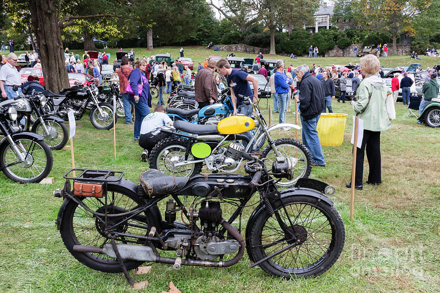 Visitors admire a row of AJS motorcycles at the 2014 Rockville A Photograph by William Kuta