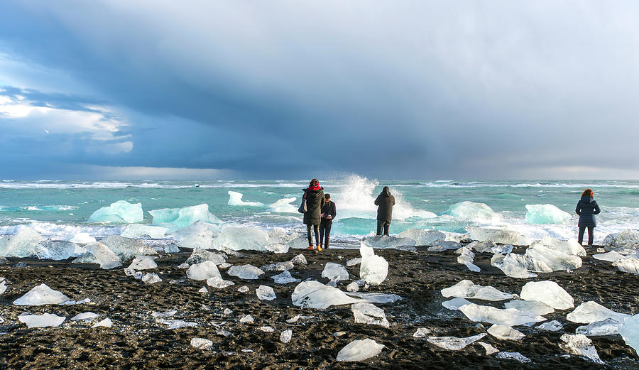 Visitors at the diamond beach, Jokulsarlon, Iceland Photograph by Dubi Roman