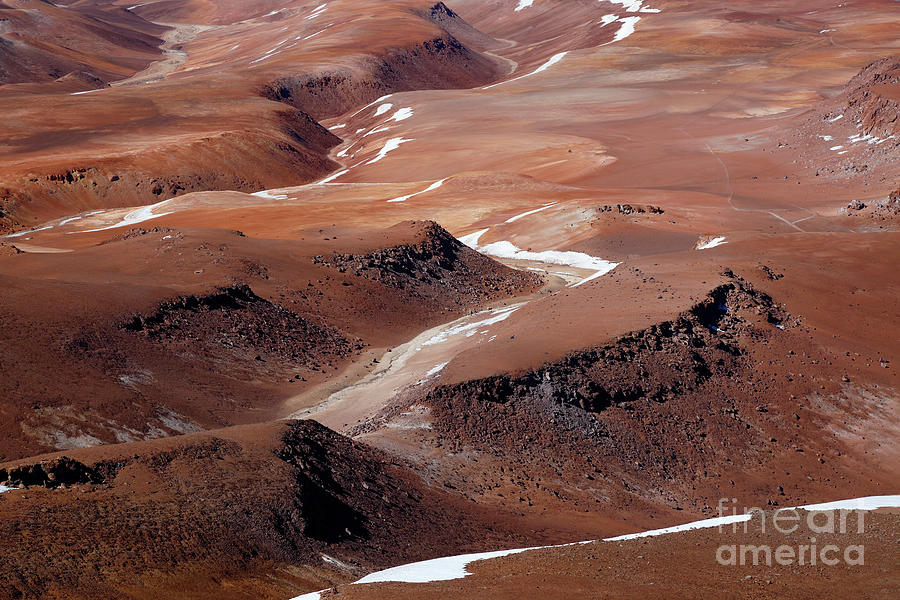 Volcanic rock outcrops and valleys in the Puna de Atacama desert Chile Photograph by James Brunker