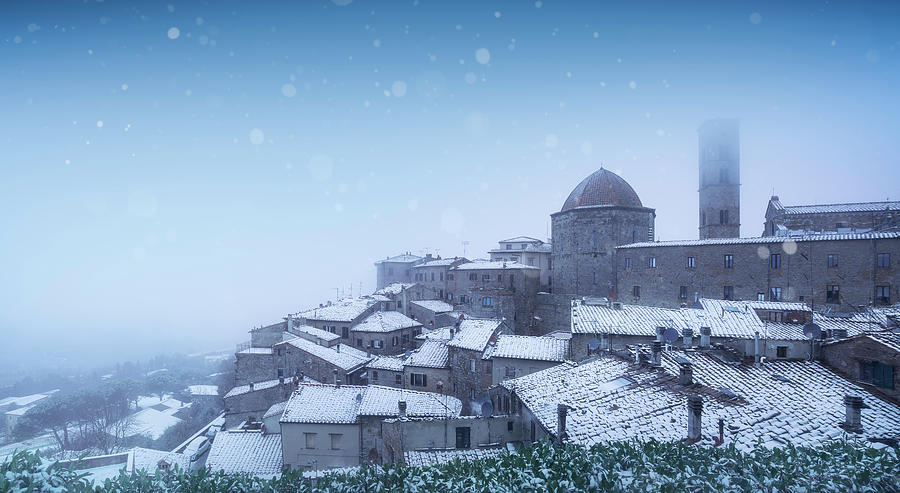 Volterra village during a snowfall in winter. Tuscany, Italy Photograph by Stefano Orazzini