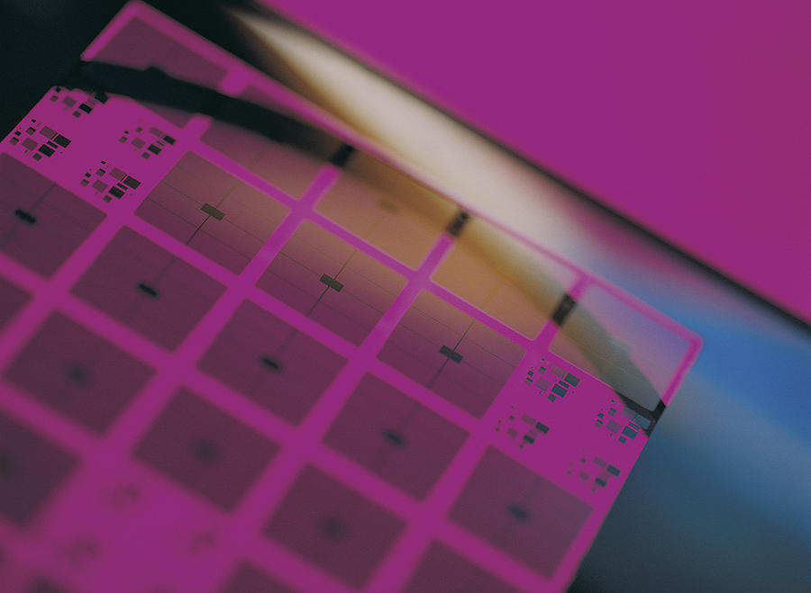 Wafer-chip abstraction overlaid with magenta etching Photograph by Chris Knapton