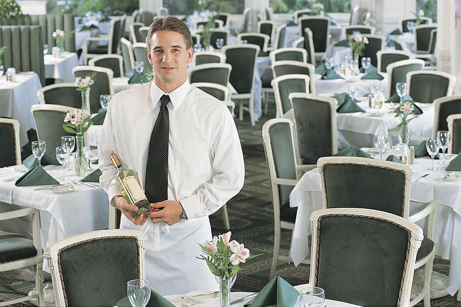 Waiter with bottle of wine Photograph by Comstock