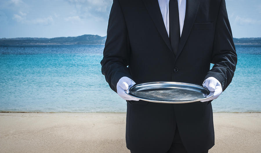 Waiter with tray on the beach Photograph by Stefano Oppo