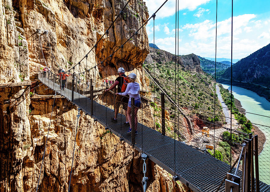 Walkers on the El Caminito del Rey walking trail, pinned along the steep walls of a narrow gorge Photograph by Panoramic Images