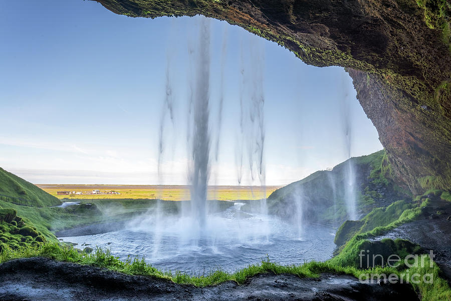 Walking behind Seljalandsfoss waterfall, Iceland Photograph by Delphimages Photo Creations