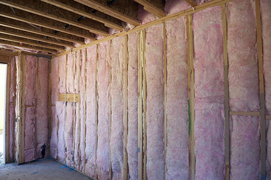 Wall of pink insulation in house Photograph by Kevinjeon00