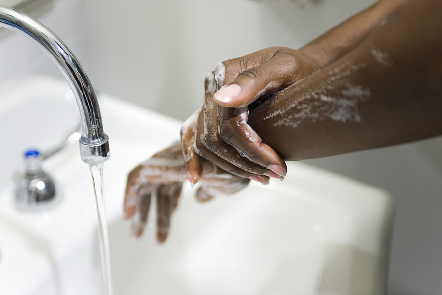 Washing hands Photograph by PhotoAlto/Odilon Dimier