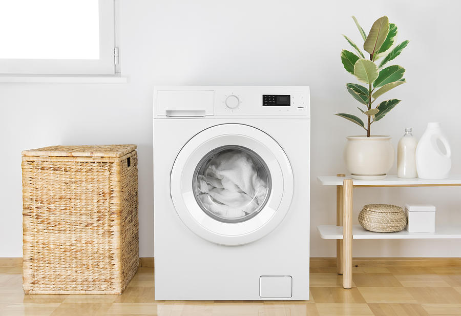 Washing machine with clothes in modern bathroom interior Photograph by Didecs