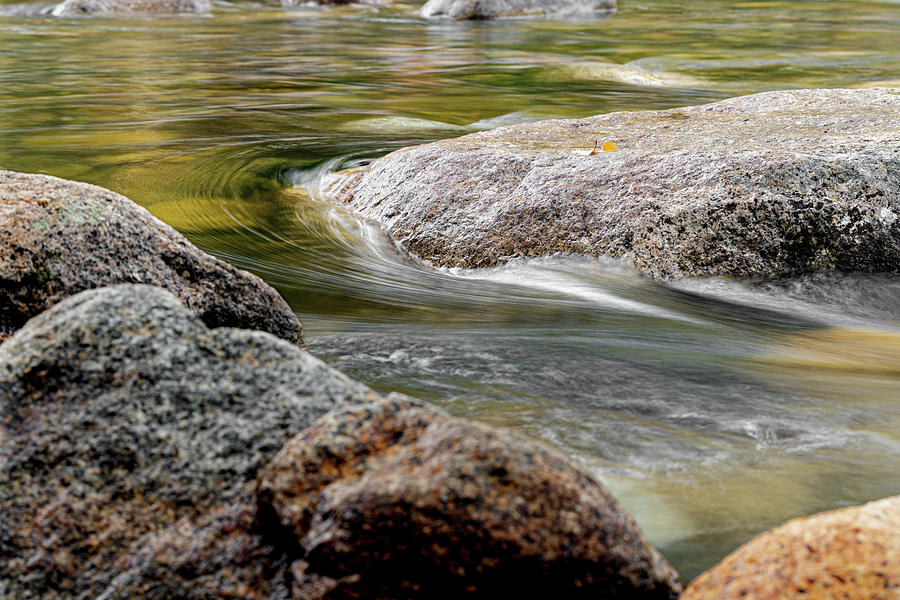 Water Curving Around A Stone Photograph